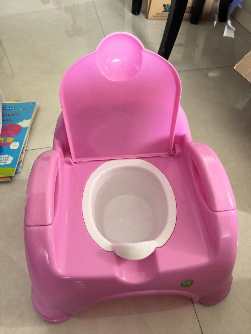 Potty Trainer 2in 1 pink (Category: Kids Tables & Chairs) located in Taguig. Submitted by ariasclosetph (Listing ID 1461865799, Image 2). Description: Never used. may sticker lang nadikit na hindi na matanggal.