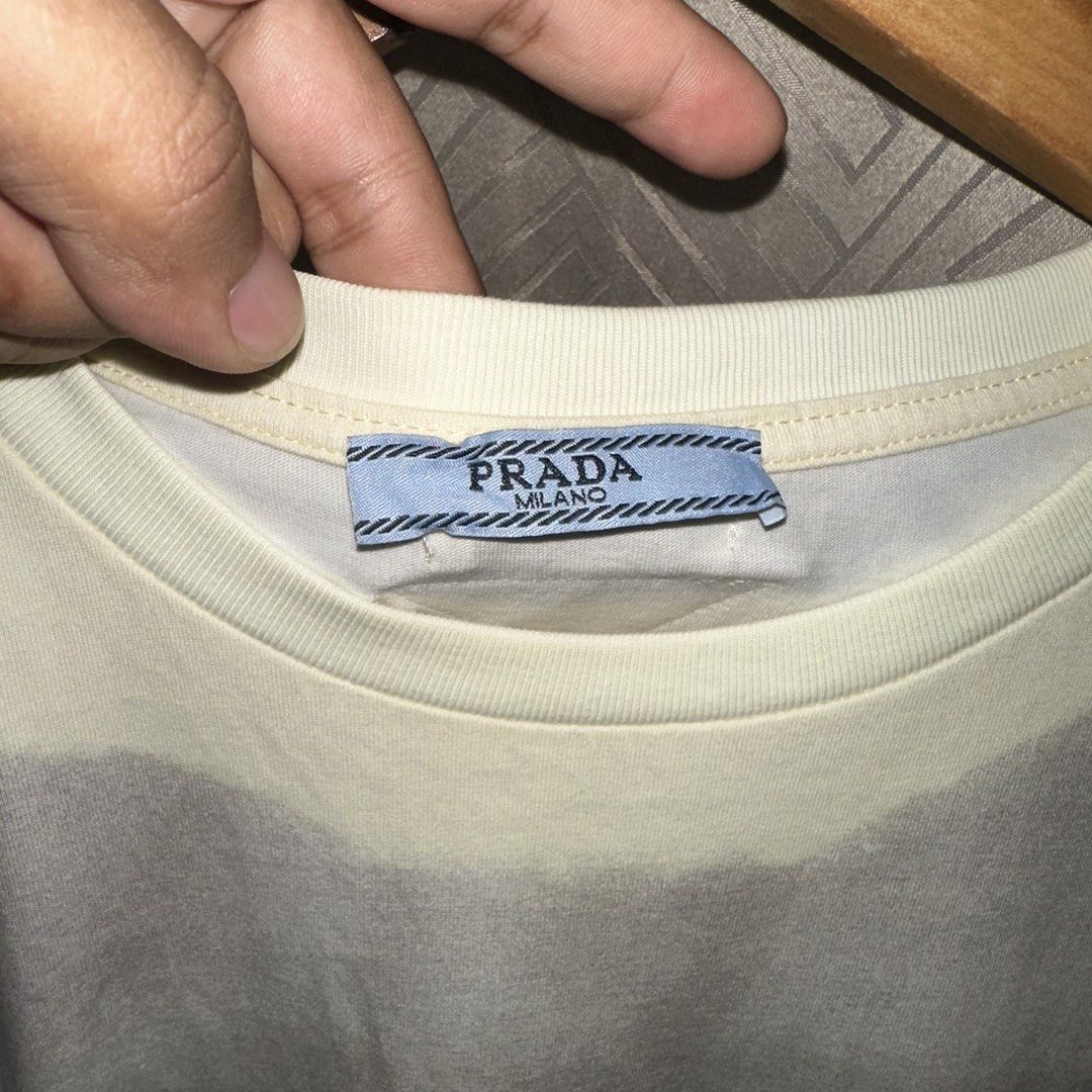 Prada Milano Tie-Dye T-Shirt (Category: Tshirts & Polo Shirts ) located in Quezon City. Submitted by retroboominwantsummoh (Listing ID 1461975423, Image 3). Description: - Authentic Prada T-Shirt - Unique tie-dye pattern with a distressed finish - Iconic Prada triangle logo on the front - Size: Large (L) - Perfect addition to your collection.