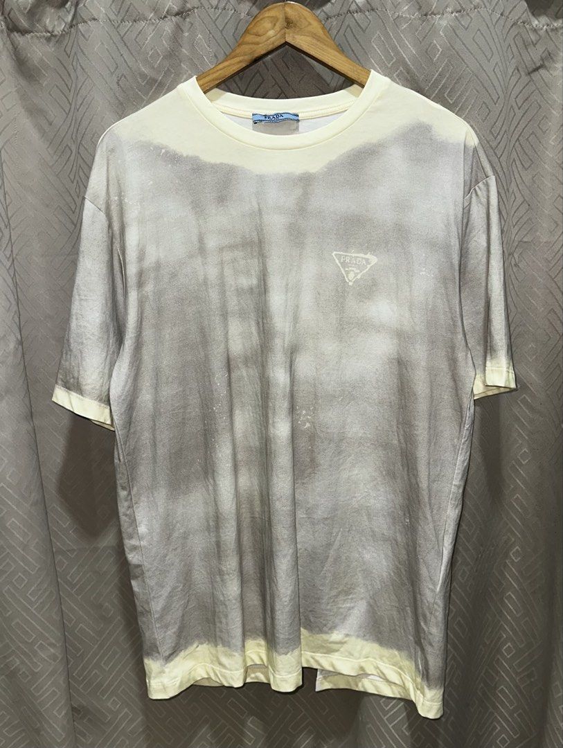Prada Milano Tie-Dye T-Shirt (Category: Tshirts & Polo Shirts ) located in Quezon City. Submitted by retroboominwantsummoh (Listing ID 1461975423, Image 1). Description: - Authentic Prada T-Shirt - Unique tie-dye pattern with a distressed finish - Iconic Prada triangle logo on the front - Size: Large (L) - Perfect addition to your collection.