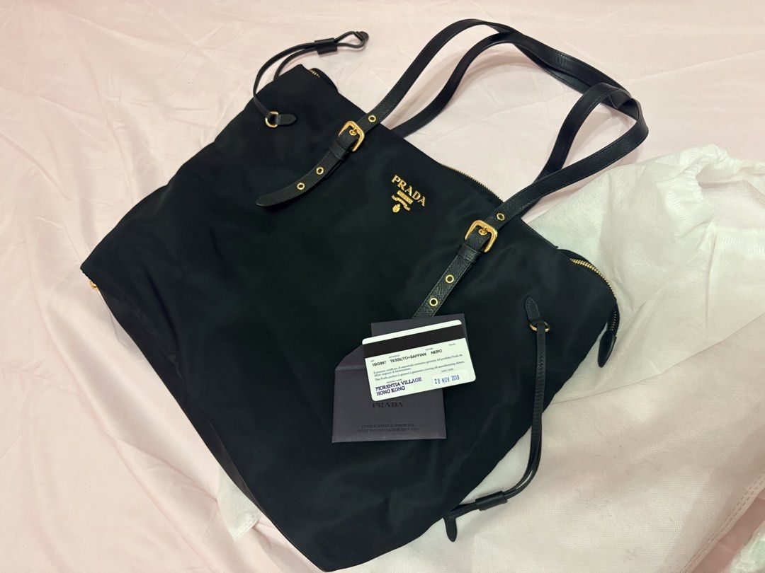 Prada Tessuto Nylon Tote Bag Nero Gold Hardware (Category: Luxury Bags & Wallets) located in Bacoor. Submitted by preownedparadyse (Listing ID 1461843390, Image 1). Description: - Authentic Prada Tessuto nylon tote bag - Elegant gold hardware details - Durable leather handles and trim - Multiple interior zip pockets for organization - Comes with authenticity card - Has small nailscratch at the back.
