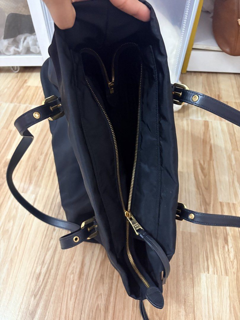 Prada Tessuto Nylon Tote Bag Nero Gold Hardware (Category: Luxury Bags & Wallets) located in Bacoor. Submitted by preownedparadyse (Listing ID 1461843390, Image 2). Description: - Authentic Prada Tessuto nylon tote bag - Elegant gold hardware details - Durable leather handles and trim - Multiple interior zip pockets for organization - Comes with authenticity card - Has small nailscratch at the back.