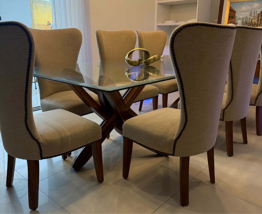 PRE-LOVED SET OF 8 ELEGANT DINING CHAIRS (Category: Tables & Sets) located in Taguig. Submitted by decluttering.stylist (Listing ID 1461807672, Image 1). Description: Selling our 8 pcs cream upholstered high-back dining chairs 🤍 - Elegant modern-classic design - Neutral cream/beige upholstery - Wooden legs - Beautiful nailhead trim detail - Comfortable and sturdy - Well-maintained pre-loved condition - Perfect for a dining room or accent seating