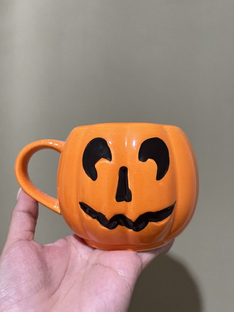 Pumpkin Face Mug Halloween Ceramic Orange (Category: Coffee & Tea Tableware) located in Manila. Submitted by vaughnscloset (Listing ID 1461948659, Image 1). Description: - Adorable pumpkin-shaped mug - Made of durable orange ceramic - Features a fun carved pumpkin face design - Comfortable, easy-to-grip handle - Ideal for coffee, tea, hot chocolate, and other beverages - Perfect for Halloween or year-round festive decor - Brightens up your kitche