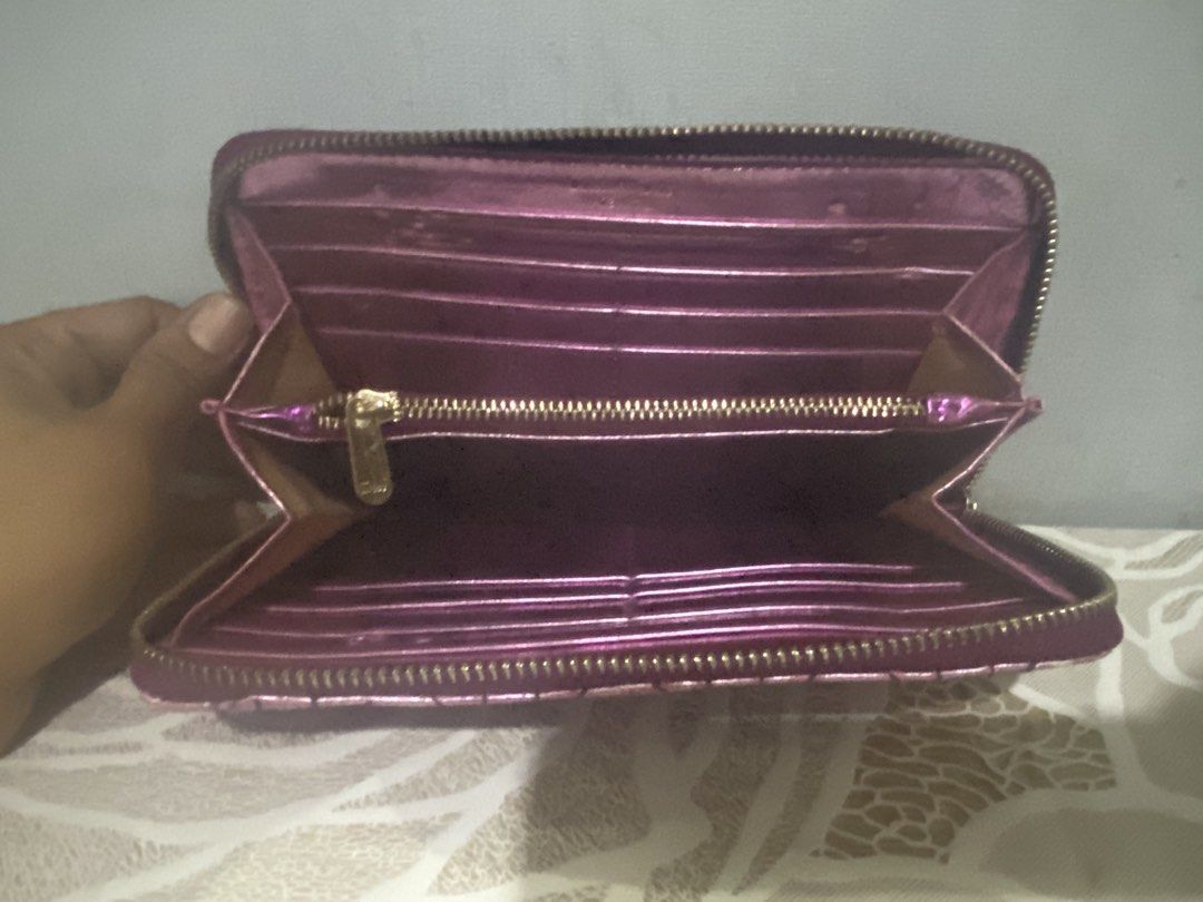 Purple Metallic Quilted Zip Around Wallet (Category: Wallets & Card holders) located in Cagayan de Oro. Submitted by ericlarkyl89146 (Listing ID 1461850285, Image 3). Description: - Stylish purple metallic wallet - Elegant quilted design - Secure zip-around closure - Ample card slots and compartments for organization - Adorable charm attached to the zipper - Ideal for everyday use and keeping essentials tidy.