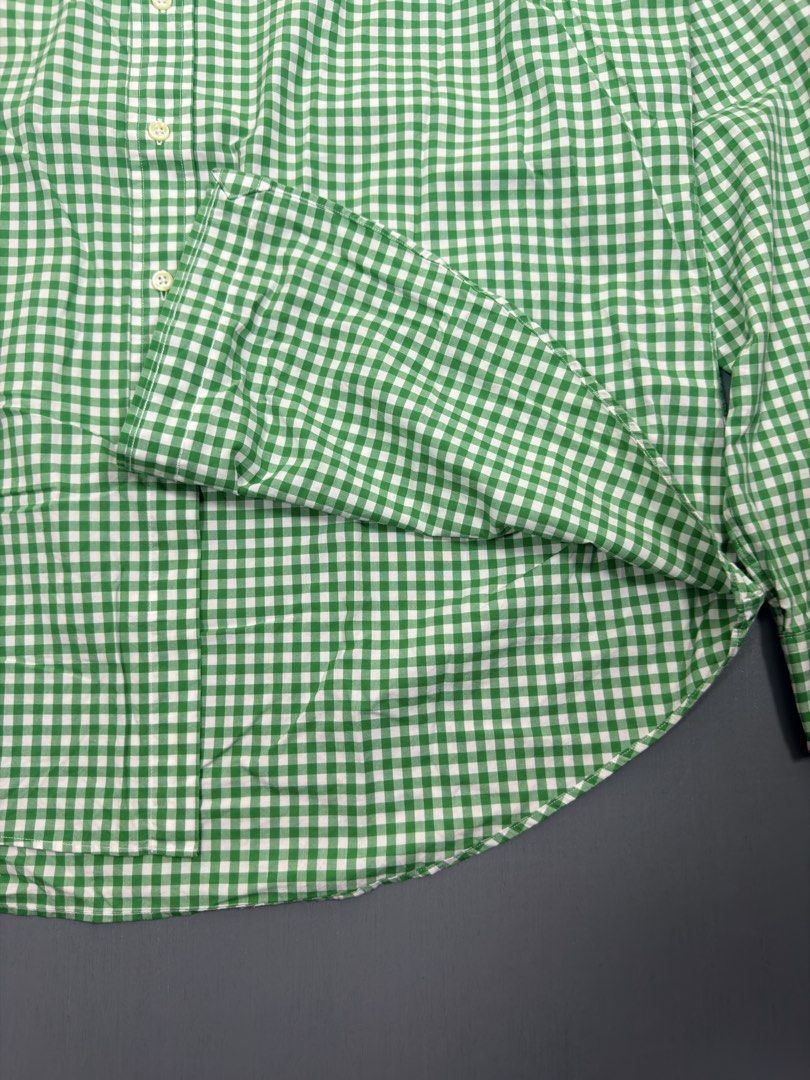 Ralph Lauren Green Gingham Button-Up Shirt (Category: Tshirts & Polo Shirts ) located in Manila. Submitted by presidentr52451 (Listing ID 1462025523, Image 3). Description: - Classic green and white gingham pattern Width 26✅ Length 30✅ - Ralph Lauren brand - Signature pink pony logo embroidered on chest - Button-down collar - Long sleeves with button cuffs - Versatile for casual and smart-casual outfits - Pairs well with jeans or chinos.