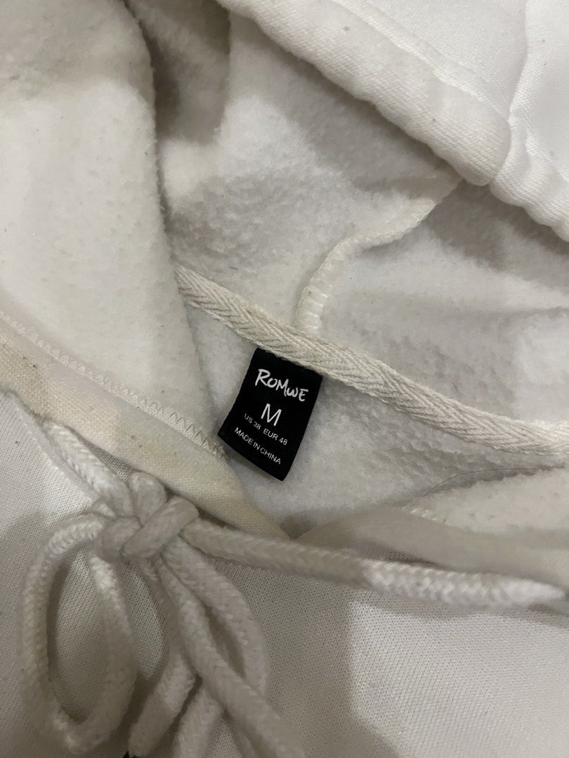 Random ROMWE White Hoodie Size M (Category: Hoodies) located in Digos. Submitted by nasosaaa (Listing ID 1461961521, Image 2). Description: - White hoodie from ROMWE - Size: Medium (M) - Features a front pocket - Adjustable drawstring hood - Basic and comfortable design - Ideal for casual wear.