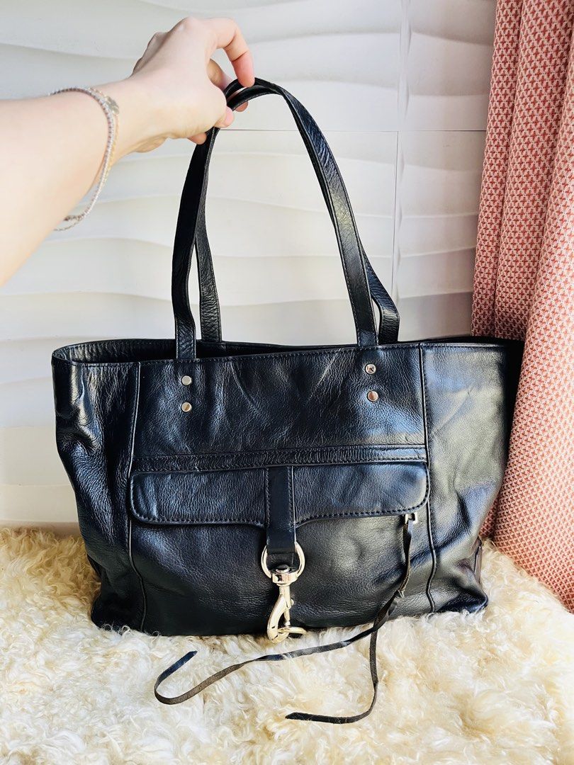 Rebecca Minkoff Black Leather Tote Bag (Category: Tote Bags) located in Davao. Submitted by goodthingsph_ (Listing ID 1462033643, Image 1). Description: - Classic black leather tote bag from Rebecca Minkoff - Spacious interior with patterned lining - Front flap pocket with silver clasp closure - Comfortable top handles for carrying - Perfect for work or everyday casual use.