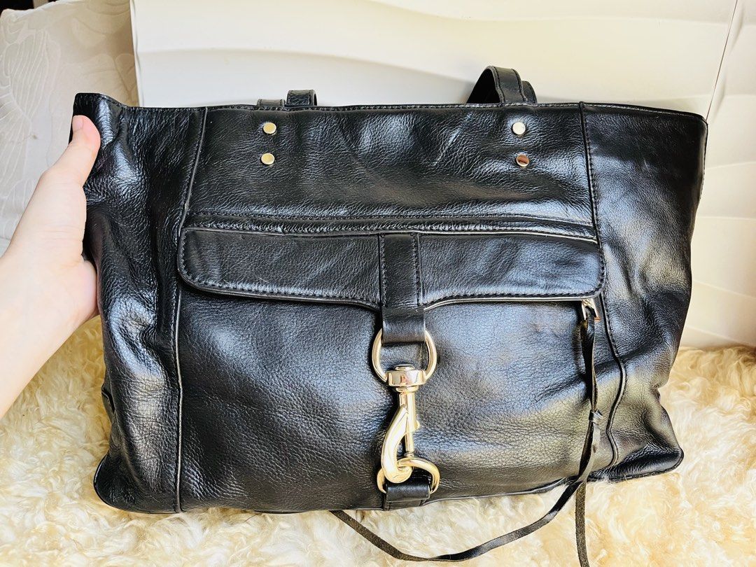 Rebecca Minkoff Black Leather Tote Bag (Category: Tote Bags) located in Davao. Submitted by goodthingsph_ (Listing ID 1462033643, Image 3). Description: - Classic black leather tote bag from Rebecca Minkoff - Spacious interior with patterned lining - Front flap pocket with silver clasp closure - Comfortable top handles for carrying - Perfect for work or everyday casual use.