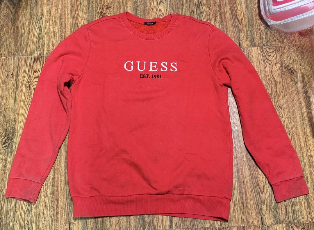 Red Guess Est. 1981 Sweatshirt XL (Category: Coats, Jackets and Outerwear) located in Manila. Submitted by bunsmayo31 (Listing ID 1461991659, Image 1). Description: - Classic red Guess sweatshirt - Iconic 'Guess Est. 1981' embroidered logo on front - Comfortable cotton blend fabric - Size XL - Ideal for casual everyday wear - A wardrobe staple piece.