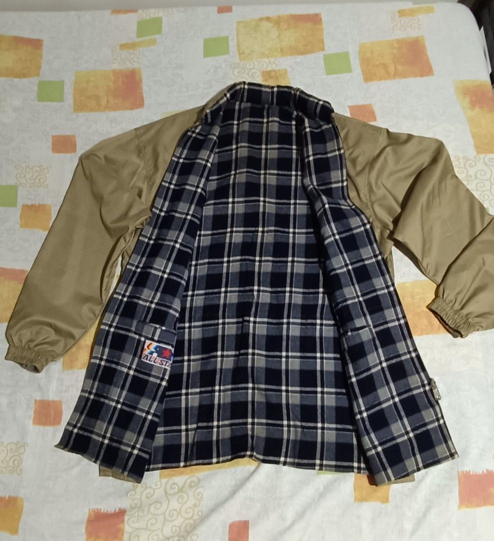 Reversible Khaki Jacket with Plaid Lining (Category: Coats, Jackets and Outerwear) located in Imus. Submitted by snapandsketch (Listing ID 1461823199, Image 3). Description: - Khaki jacket with a stylish plaid lining. - Water repellent - Reverse side is made of franella - Adjustable drawstring waist for a personalized fit. - Convenient pockets: two on the front and one on the chest. - Attached hood for added versatility. - Ideal for casual wear a