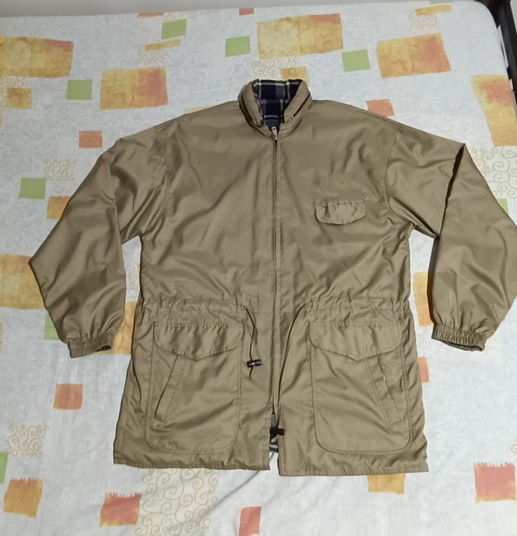 Reversible Khaki Jacket with Plaid Lining (Category: Coats, Jackets and Outerwear) located in Imus. Submitted by snapandsketch (Listing ID 1461823199, Image 1). Description: - Khaki jacket with a stylish plaid lining. - Water repellent - Reverse side is made of franella - Adjustable drawstring waist for a personalized fit. - Convenient pockets: two on the front and one on the chest. - Attached hood for added versatility. - Ideal for casual wear a