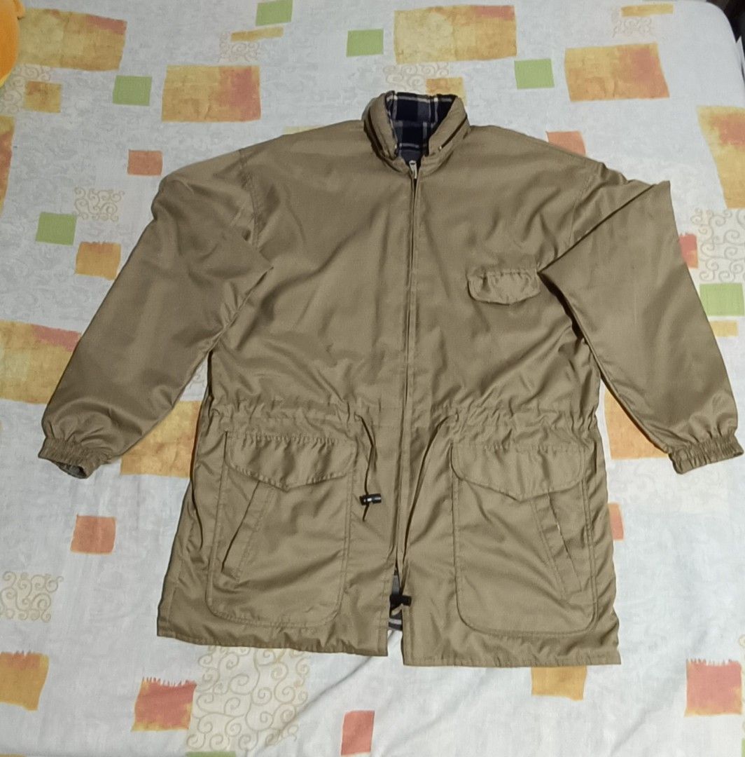Reversible Khaki Jacket with Plaid Lining (Category: Coats, Jackets and Outerwear) located in Imus. Submitted by snapandsketch (Listing ID 1461823199, Image 2). Description: - Khaki jacket with a stylish plaid lining. - Water repellent - Reverse side is made of franella - Adjustable drawstring waist for a personalized fit. - Convenient pockets: two on the front and one on the chest. - Attached hood for added versatility. - Ideal for casual wear a