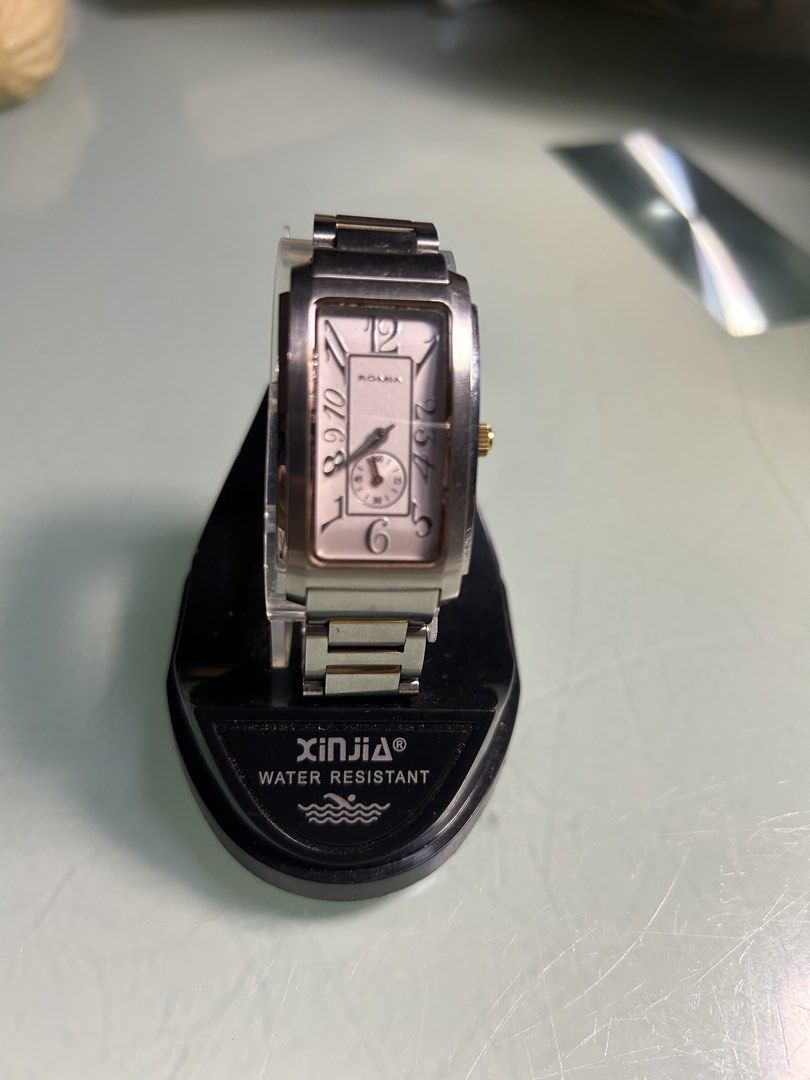 ROMIA Rectangular Watch - Two-Tone Stainless Steel (Category: Women's Watches) located in Cavite. Submitted by mamamia73 (Listing ID 1461985088, Image 1). Description: Rectangular watch with a two-tone stainless steel band. Silver dial with gold accents and Roman numerals. Small sub-dial for seconds. Water resistant. Clasp closure. Band has some signs of wear. Selling as is..