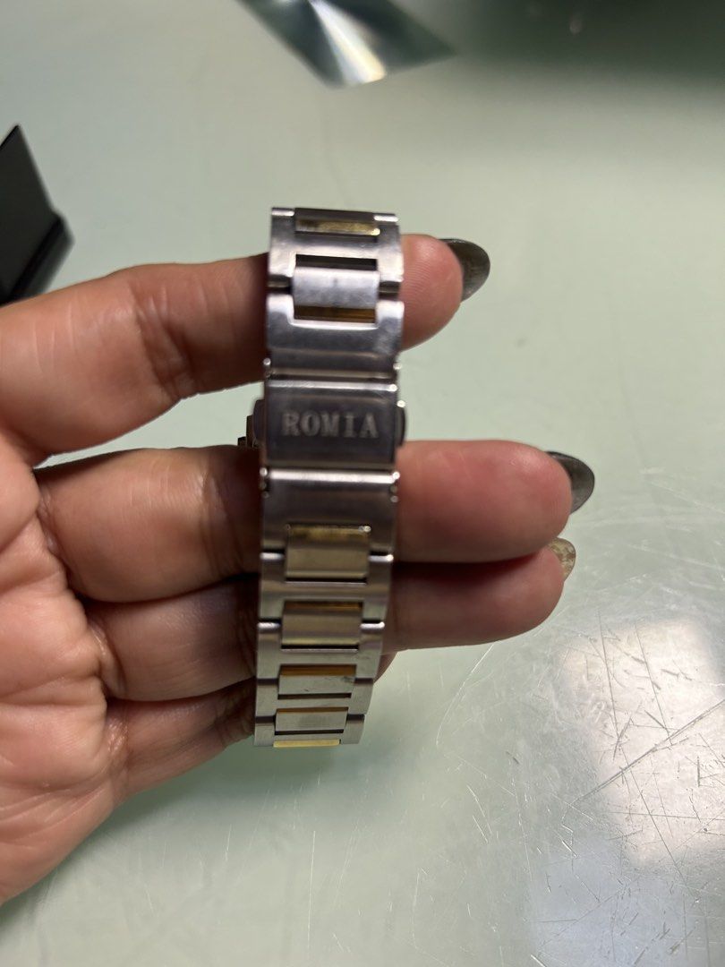 ROMIA Rectangular Watch - Two-Tone Stainless Steel (Category: Women's Watches) located in Cavite. Submitted by mamamia73 (Listing ID 1461985088, Image 2). Description: Rectangular watch with a two-tone stainless steel band. Silver dial with gold accents and Roman numerals. Small sub-dial for seconds. Water resistant. Clasp closure. Band has some signs of wear. Selling as is..
