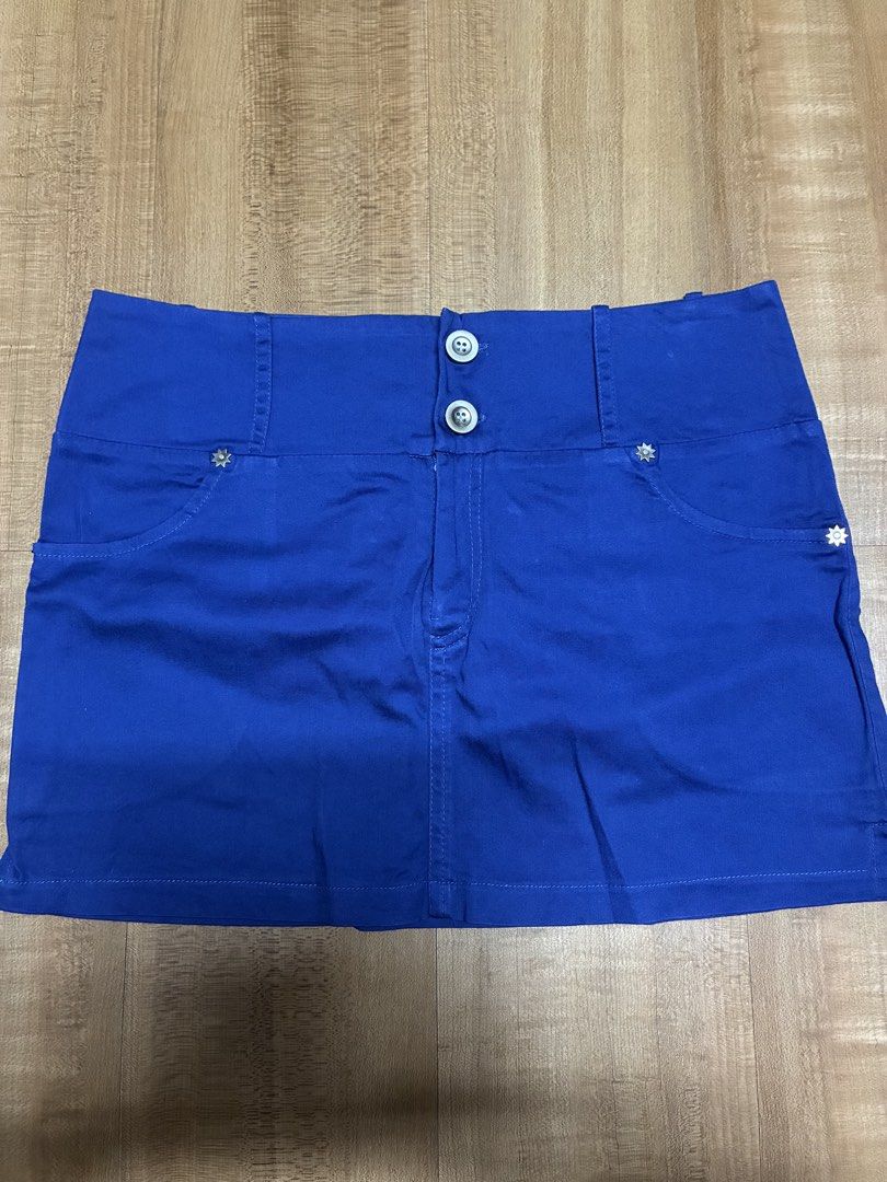 Royal Blue Mini Skirt with Button Detail (Category: Skirts) located in Quezon City. Submitted by habits.mnl (Listing ID 1461846326, Image 1). Description: - Cute blue mini skirt - Two button details at the front - Pockets with star embellishment - Versatile for casual or dressed-up outfits - Easy to pair with various tops.