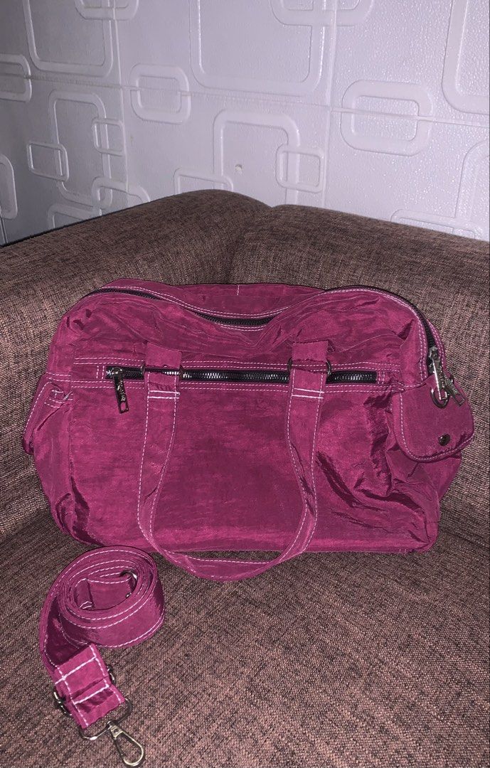 Ruffles Shoulder Bag (Category: Shoulder Bags) located in Manila. Submitted by jei_sol (Listing ID 1461906270, Image 2). Description: - Magenta nylon handbag by Ruffles - Multiple easy-access pockets on the front - Secure main zipper closure - Includes a detachable shoulder strap - Ample interior space for everyday essentials - Ideal for daily use.