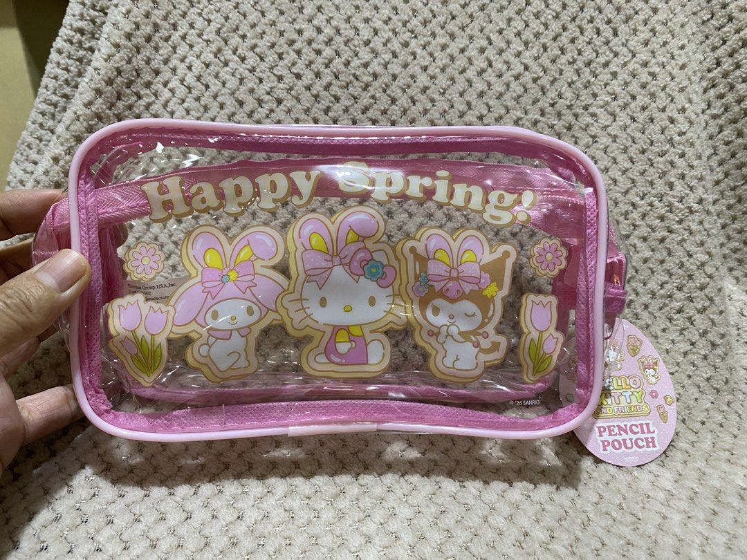 Sanrio “Happy Spring!” clear pink pencil pouch (Category: Purses & Pouches) located in Cavite. Submitted by momrocks (Listing ID 1461820709, Image 1). Description: Sanrio “Happy Spring!” clear pink pencil pouch featuring Hello Kitty, My Melody, and Kuromi wearing bunny ears Product DetailsDesign: A clear vinyl pouch with a bright pink zipper border and the words “Happy Spring!” printed across the top. Characters: Die-cut or printed inserts show H