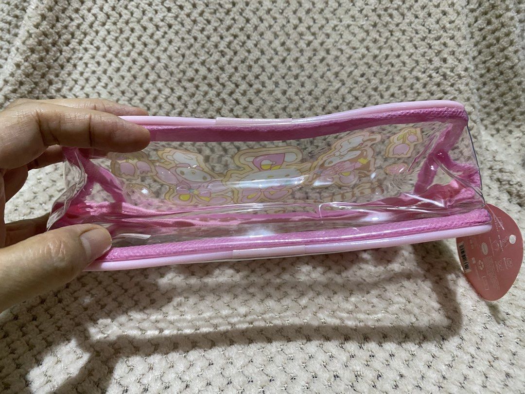Sanrio “Happy Spring!” clear pink pencil pouch (Category: Purses & Pouches) located in Cavite. Submitted by momrocks (Listing ID 1461820709, Image 2). Description: Sanrio “Happy Spring!” clear pink pencil pouch featuring Hello Kitty, My Melody, and Kuromi wearing bunny ears Product DetailsDesign: A clear vinyl pouch with a bright pink zipper border and the words “Happy Spring!” printed across the top. Characters: Die-cut or printed inserts show H