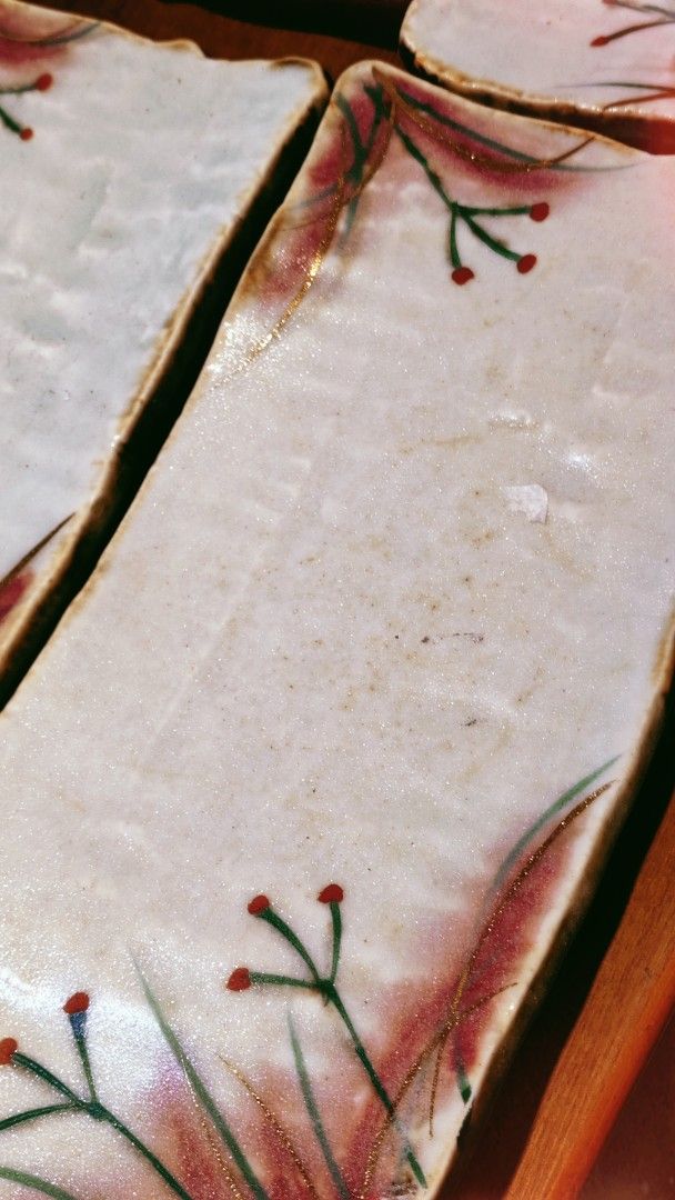 Set of 6 Rectangular Ceramic Plates with Floral Design (Category: Dinnerware & Cutlery) located in Bulacan. Submitted by babz30261 (Listing ID 1461919958, Image 3). Description: Selling a set of 6 rectangular ceramic plates. Each plate has a unique floral design with red and green accents, and a gold trim. The edges are slightly irregular, giving them a handmade feel. Great for serving appetizers or small dishes. Perfect for adding a decorative t