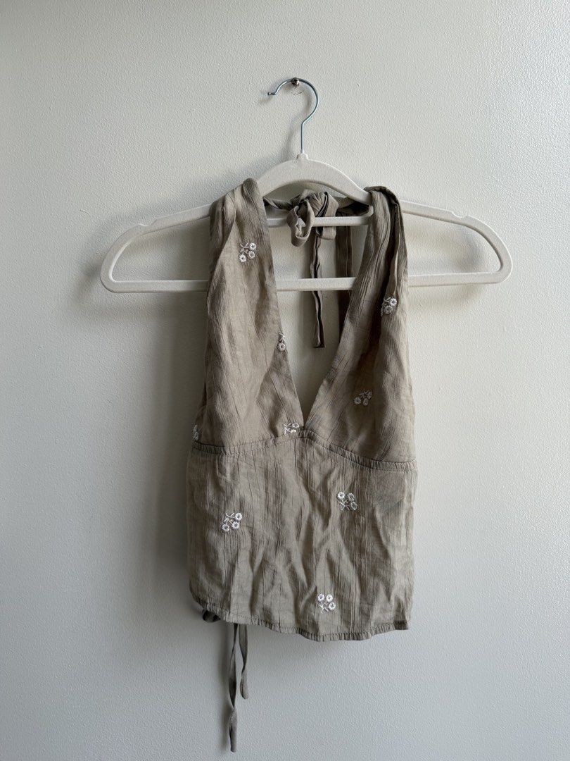 SHEIN Green Backless Halter Top (Category: Sleeveless) located in Makati City. Submitted by andy0019 (Listing ID 1461802119, Image 2). Description: - Cute beige halter neck crop top from SHEIN - Features delicate white floral embroidery - Ties at the neck and back for an adjustable fit - Lightweight fabric, perfect for summer - Size XS.
