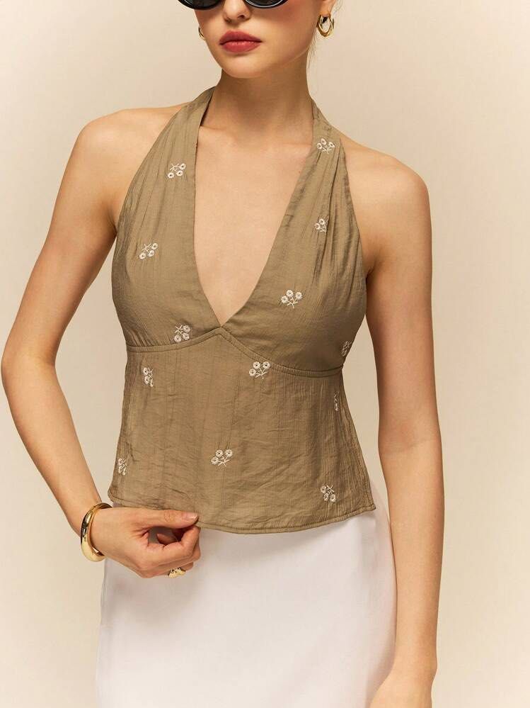 SHEIN Green Backless Halter Top (Category: Sleeveless) located in Makati City. Submitted by andy0019 (Listing ID 1461802119, Image 1). Description: - Cute beige halter neck crop top from SHEIN - Features delicate white floral embroidery - Ties at the neck and back for an adjustable fit - Lightweight fabric, perfect for summer - Size XS.