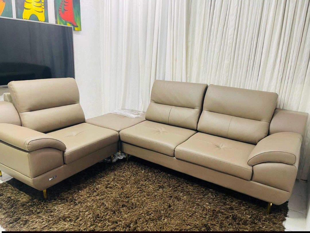SofaSet (Category: Sofas) located in Meycauayan. Submitted by marygracecasimiro (Listing ID 1461910657, Image 3). Description: From South Korea Product This is a modern taupe leather sofa featuring segmented backrests, tufted seat cushions, and sleek slim metallic legs with ottoman Dimension: L: 108 x W36 X H37 * (SL:40) Ottoman: L35x W24 x H17 Get this for only 35k💚💚.