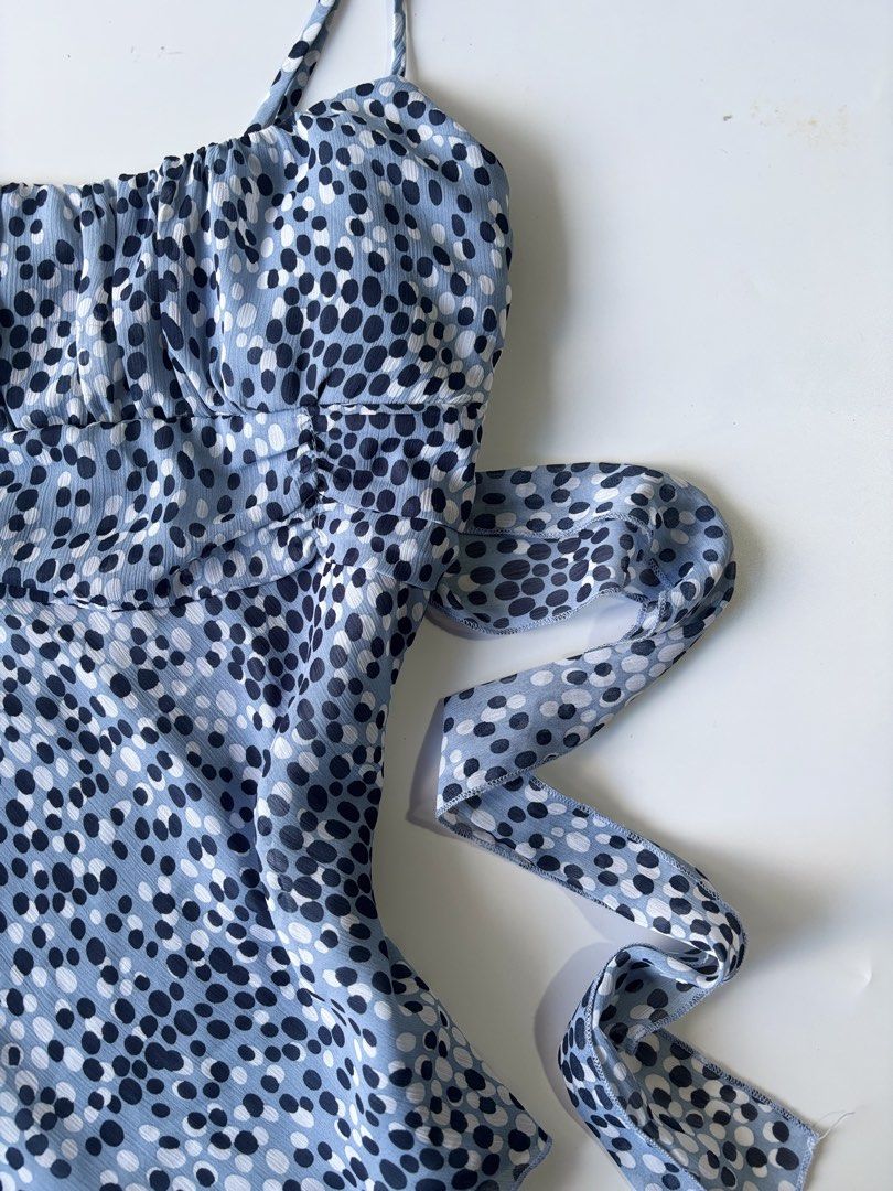 Speechless y2k Blue Dotted Camisole Top with Tie (Category: Sleeveless) located in Batac City. Submitted by doniagel (Listing ID 1461801172, Image 2). Description: - Adorable blue camisole top with a charming dotted pattern. - Features adjustable straps for a perfect fit. - Flattering ruched bust detail. - Comes with a matching tie belt to cinch your waist. - Made from lightweight, flowy fabric. - Versatile for layering or wearing solo. adjustabl