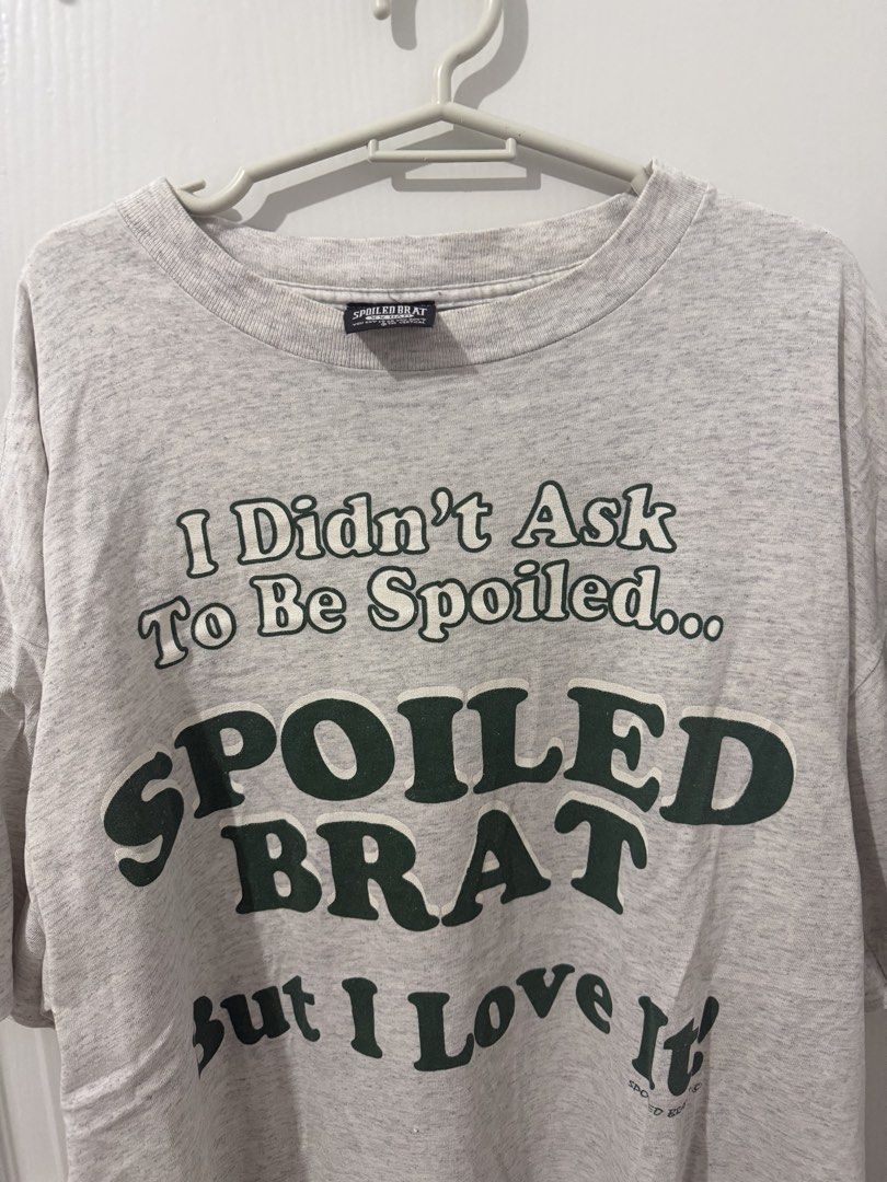 Spoiled Brat Graphic T-shirt (Category: Tshirts & Polo Shirts ) located in Manila. Submitted by driftthrift (Listing ID 1461999629, Image 1). Description: -singles all over - Grey t-shirt from the brand Spoiled Brat. - Features a fun graphic print: "I Didn't Ask To Be Spoiled... SPOILED BRAT but I Love It". - Ideal for casual wear. - Estimated size: Medium..