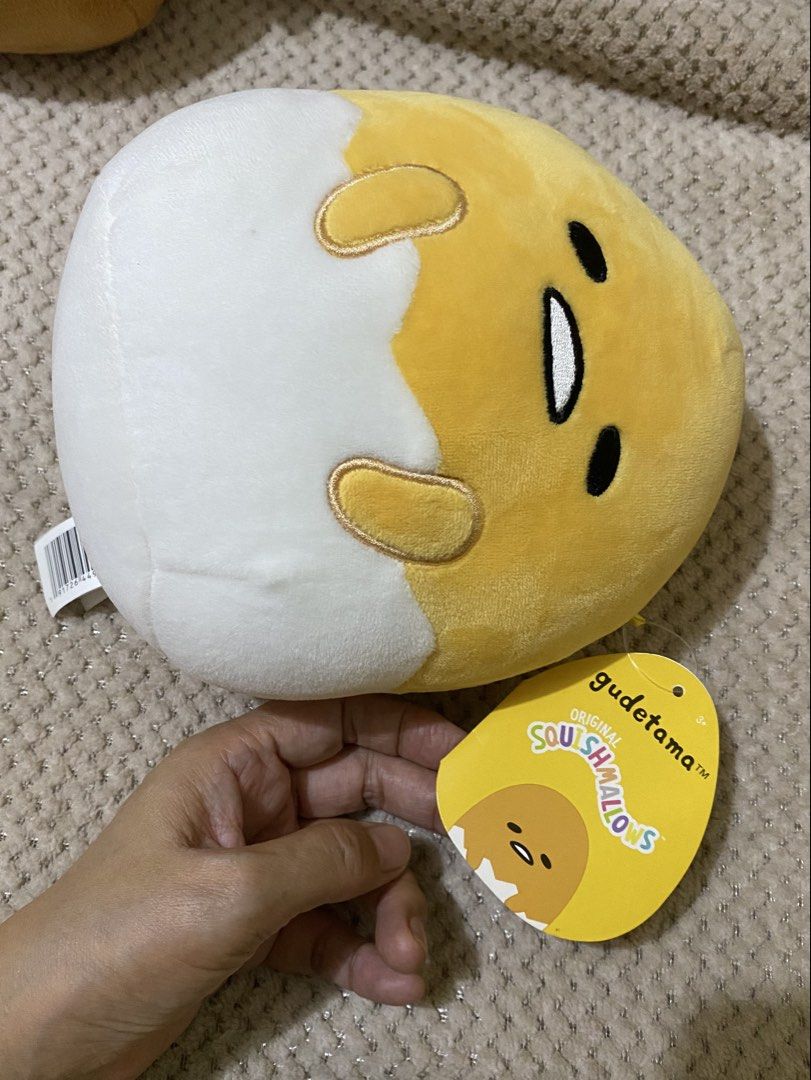 Squishmallows Sanrio Gudetama Egg Plush (Category: Plushies & Soft Toys) located in Cavite. Submitted by momrocks (Listing ID 1461847661, Image 2). Description: official Squishmallows Gudetama Egg Plush from the Sanrio squad. Product DetailsCharacter: Gudetama the Lazy Egg peeking out of a white eggshell. Material: Ultra-soft, squishy polyester. Tag: Features an authentic yellow Sanrio Gudetama hangtag..