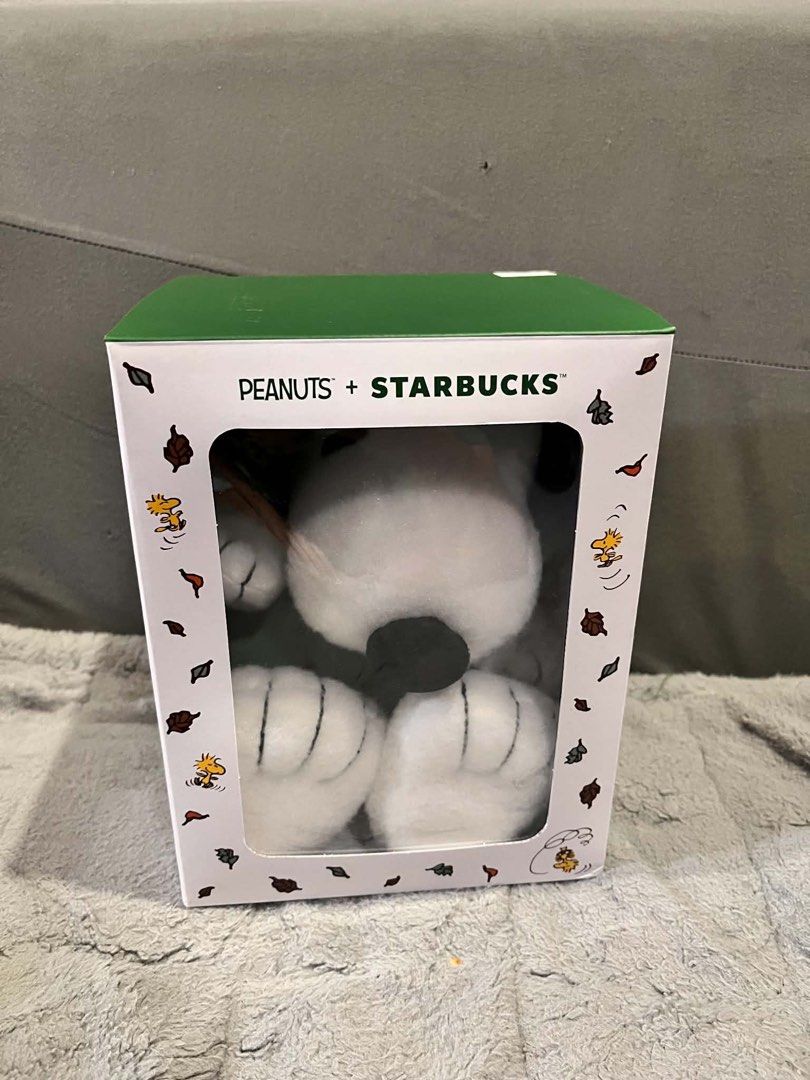 Starbucks x Peanuts Snoopy Plush Toy with Box (Category: Plushies & Soft Toys) located in Manila. Submitted by hemnl (Listing ID 1461863037, Image 2). Description: - Authentic Starbucks x Peanuts collaboration plush. - Adorable Snoopy character. - Comes brand new in its original, unopened box. - Snoopy is dressed in a green barista apron. - Holding a miniature Starbucks coffee cup. - Box features charming fall leaf illustrations. - Ideal gift for