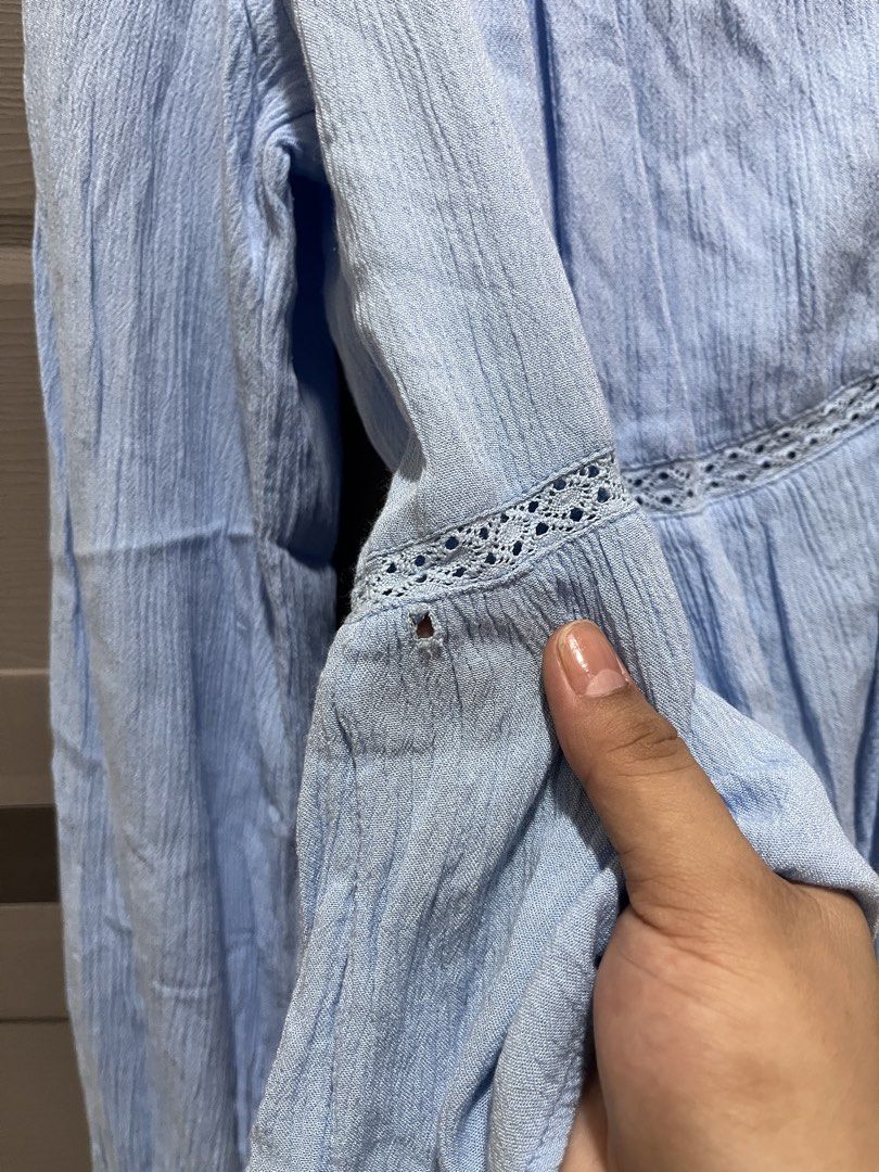 Stradivarious Light Blue Textured Long Sleeve Blouse Size L (Category: Longsleeves) located in Koronadal. Submitted by declutterprelovednitine_ey (Listing ID 1461810607, Image 3). Description: - Light blue textured blouse from Bershka - Long sleeves with delicate lace detail - Button-up front with adjustable tie at the hem - Minor flaw: small hole on the left sleeve near the cuff (refer to the last photo for exact location).