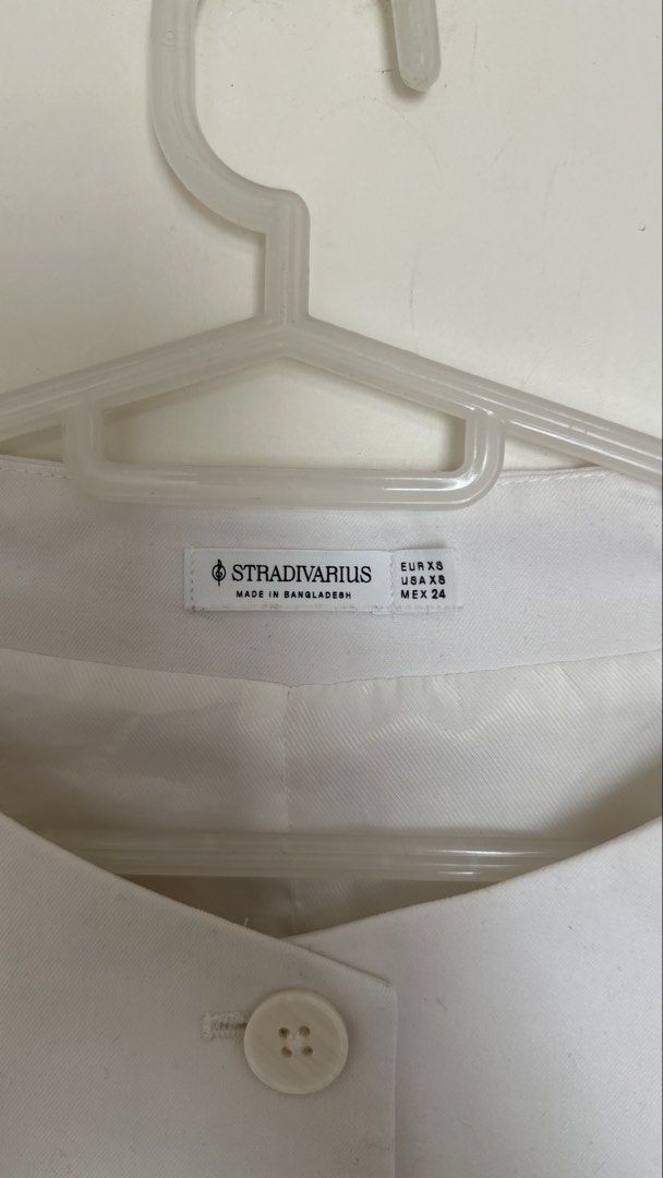 Stradivarius White Sleeveless Button-Up Vest (Category: Sleeveless) located in Mandaluyong City. Submitted by yv.stuff (Listing ID 1461831075, Image 3). Description: - White sleeveless vest from Stradivarius - Button-up front with two pocket details - Made in Bangladesh - Size XS - Perfect for layering over tops or dresses - Can be worn open or closed for a sharp look.