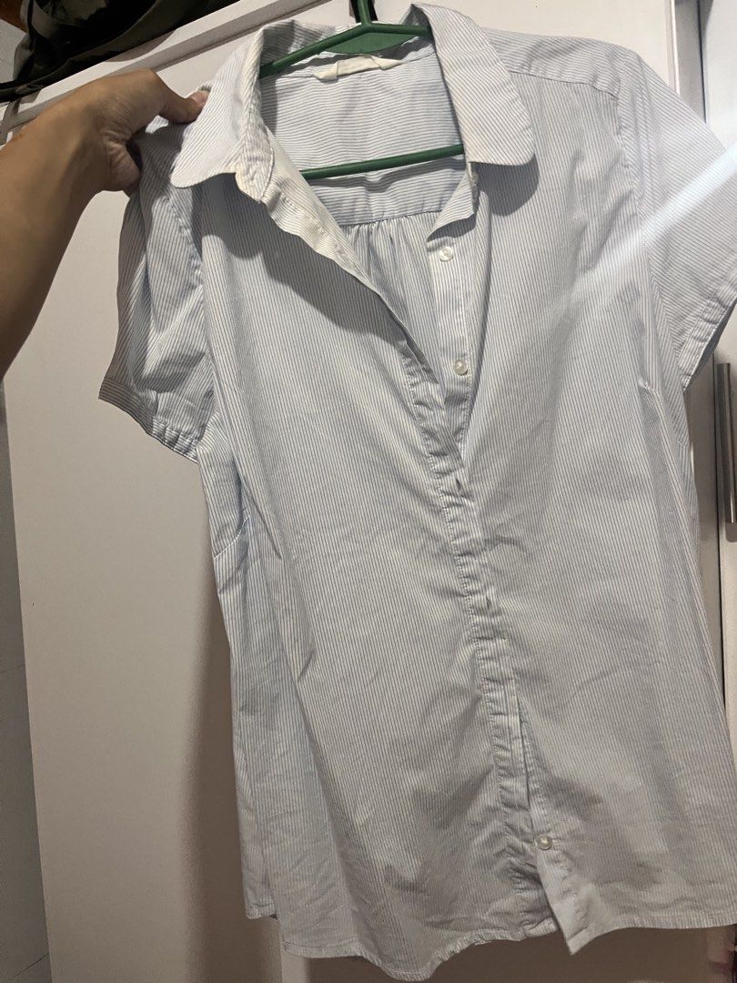 Striped Short Sleeve Button-Up Blouse (Category: Blouses) located in Manila. Submitted by chimcheese (Listing ID 1461959528, Image 2). Description: - Light blue and white striped short sleeve blouse - Button-up front with collared neckline - Subtle textured fabric - Versatile for casual or work attire - Pairs well with pants or skirts.
