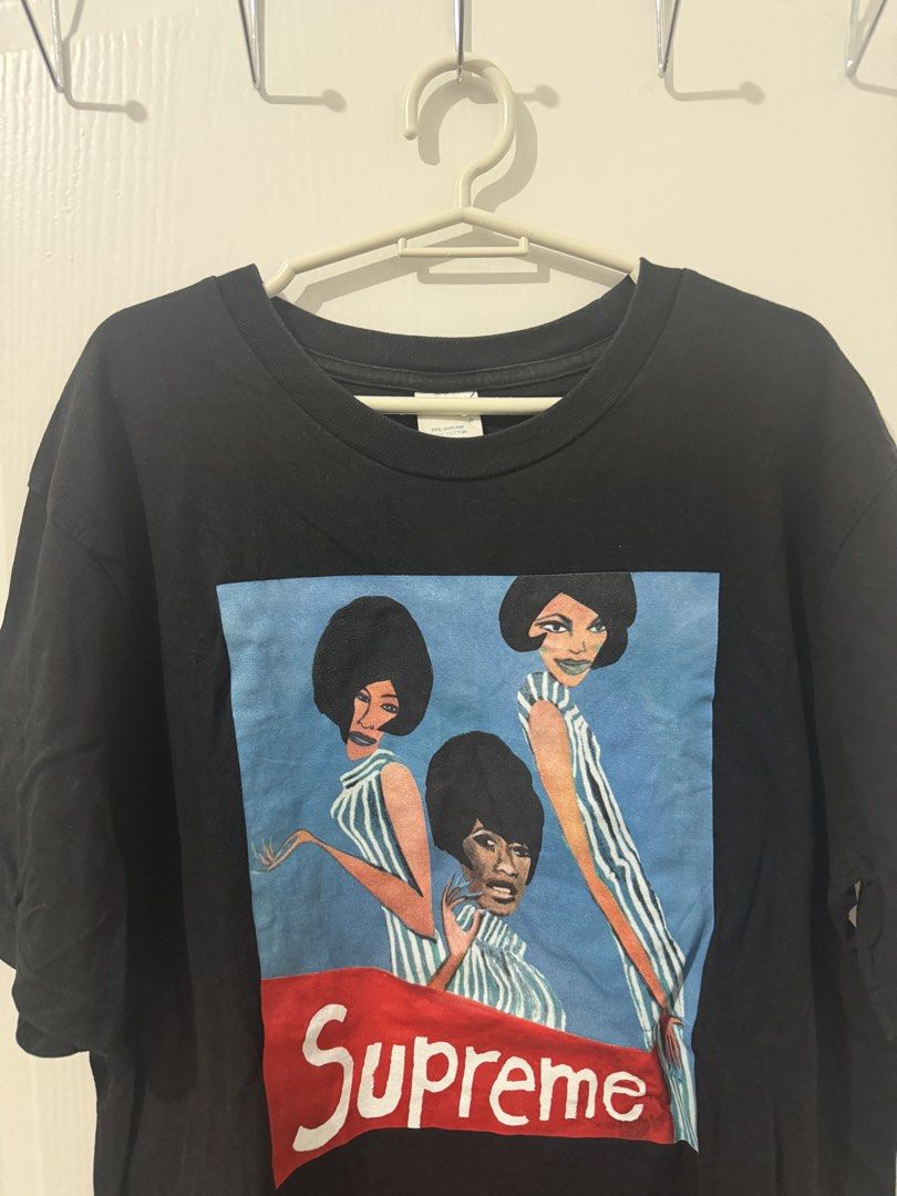 Supreme "The Three Graces" T-Shirt Black (Category: Tshirts & Polo Shirts ) located in Manila. Submitted by driftthrift (Listing ID 1461999180, Image 1). Description: - Authentic Black Supreme T-shirt - Features the 'The Three Graces' graphic print with three women in striped tops - Classic Supreme box logo detail at the bottom - Made from comfortable cotton material - Ideal for casual wear and streetwear collections.