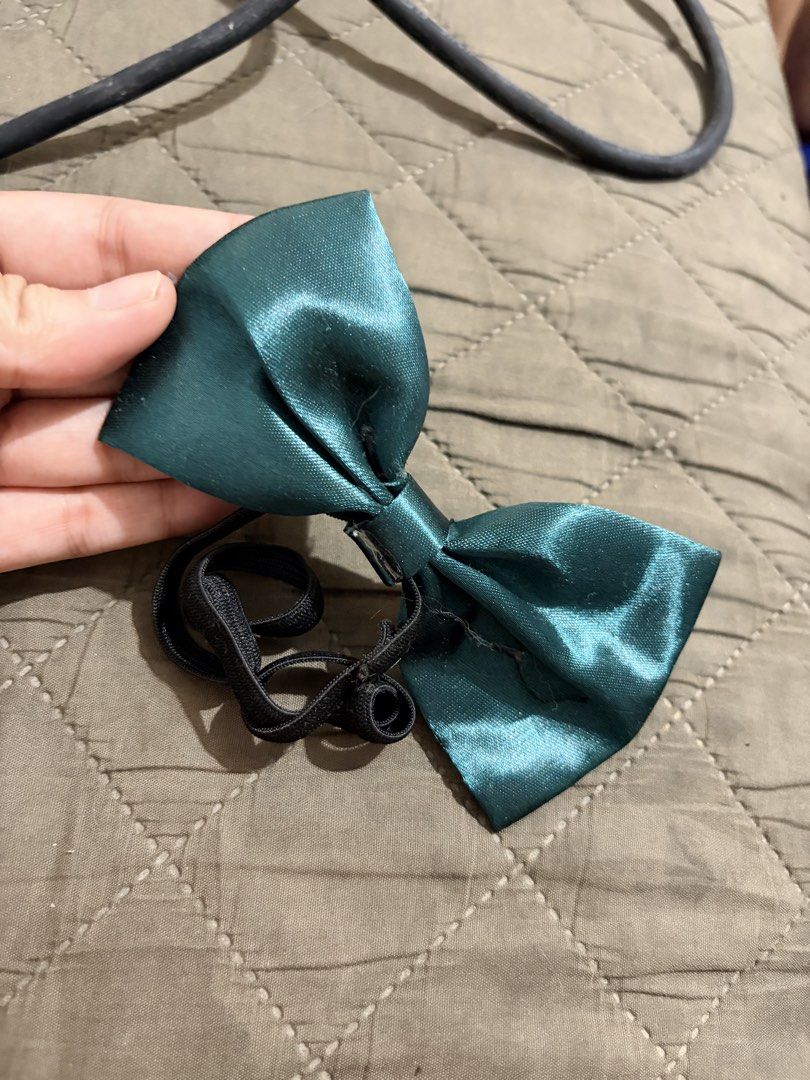 Teal Satin Bow Tie with Elastic Strap (Category: Ties) located in Manila. Submitted by finderskeepersmnl_092026 (Listing ID 1461979530, Image 1). Description: - Teal satin bow tie - Features an elastic strap - Ideal for pets or costume accessories - Smooth satin with a beautiful sheen - Black, stretchy strap.