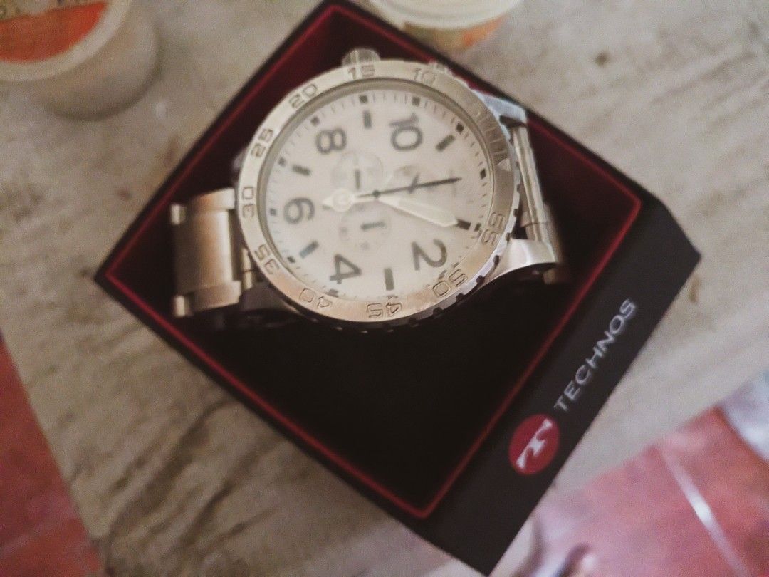 Technos Chronograph Watch White Dial (Category: Men's Watches) located in Valenzuela. Submitted by rainshia0792039 (Listing ID 1461838384, Image 2). Description: - Technos Chronograph Watch - Features a clean white dial - Durable stainless steel band - Comes with its original box - Versatile for daily wear or special events.