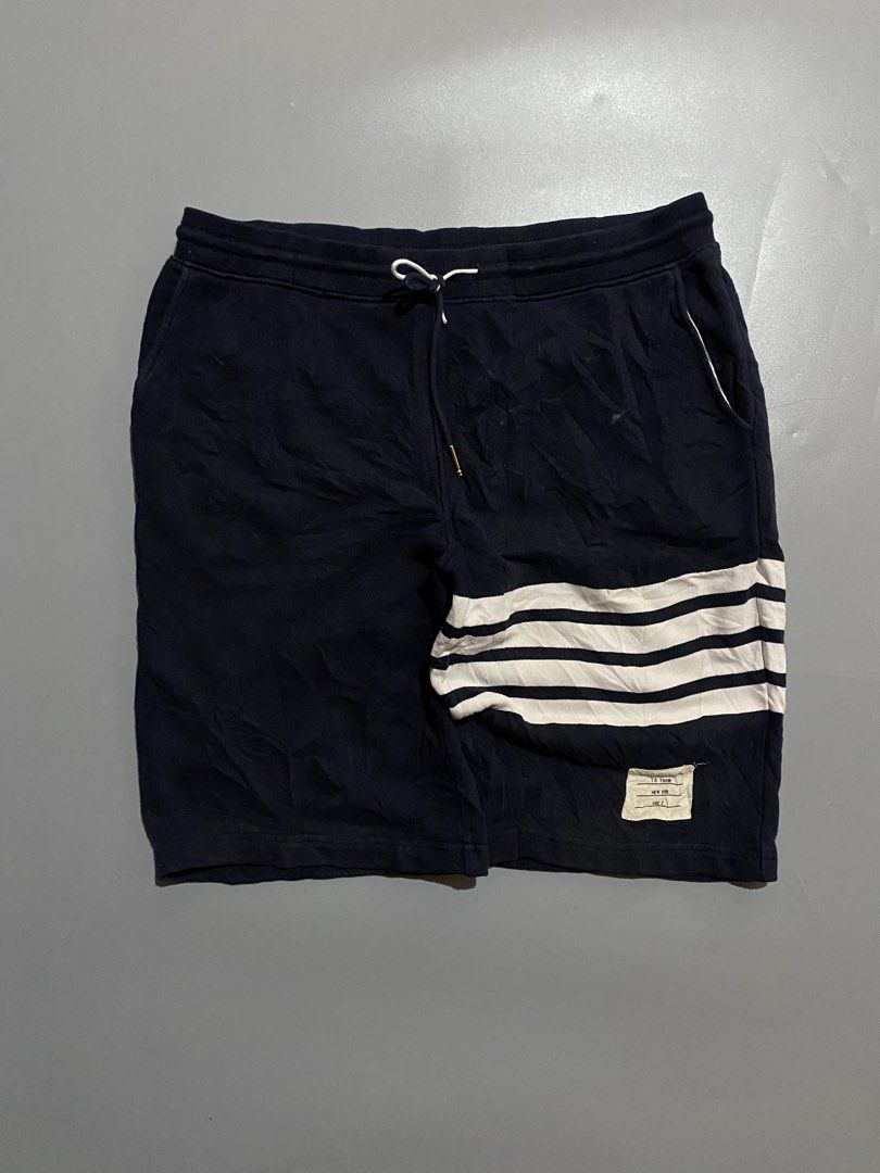 Thom Browne Navy Shorts with White Stripes (Category: Luxury Apparel) located in Manila. Submitted by delunakenn94368 (Listing ID 1461949758, Image 1). Description: - Navy blue Thom Browne shorts - Signature white stripes on the side - Comfortable drawstring waist - Features pockets - Ideal for casual wear.