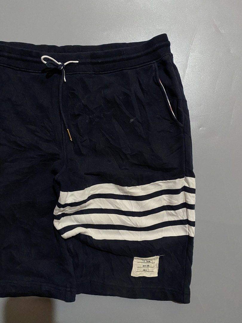 Thom Browne Navy Shorts with White Stripes (Category: Luxury Apparel) located in Manila. Submitted by delunakenn94368 (Listing ID 1461949758, Image 3). Description: - Navy blue Thom Browne shorts - Signature white stripes on the side - Comfortable drawstring waist - Features pockets - Ideal for casual wear.