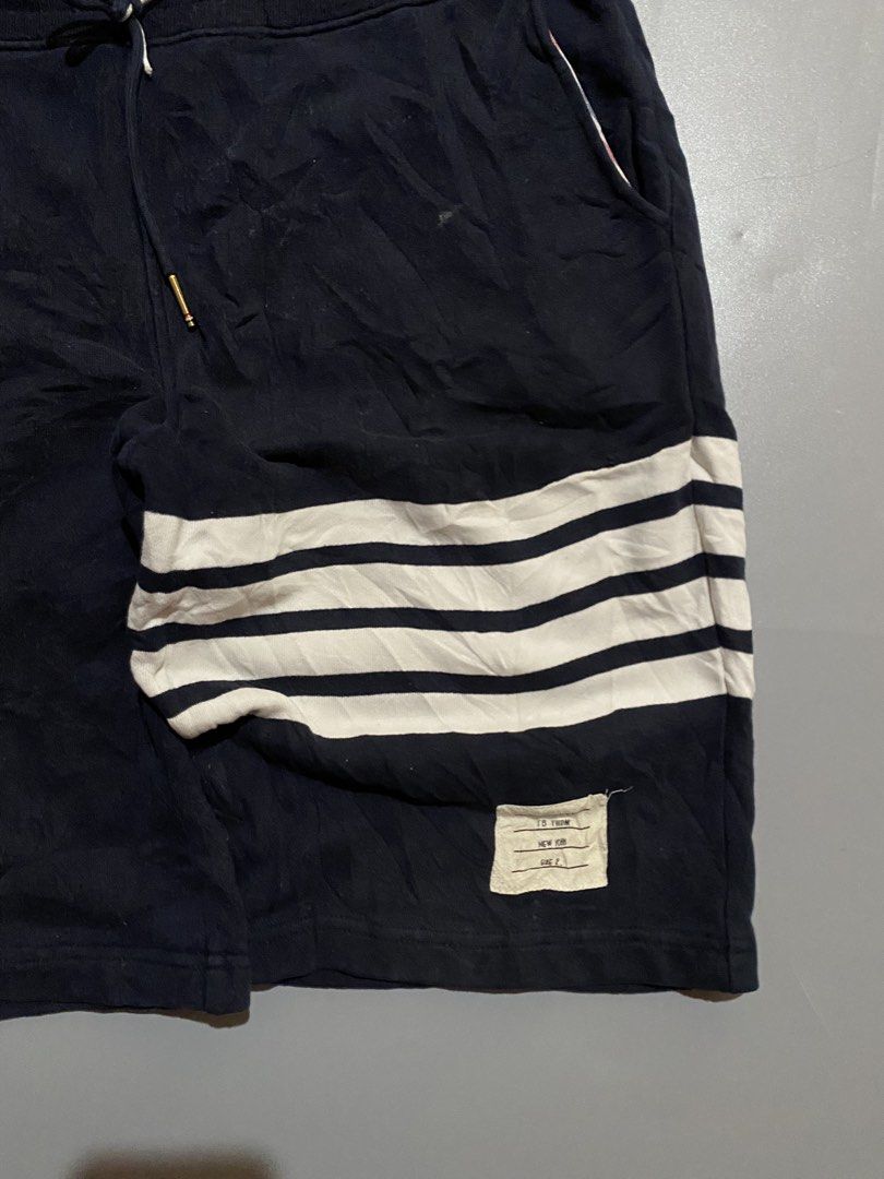 Thom Browne Navy Shorts with White Stripes (Category: Luxury Apparel) located in Manila. Submitted by delunakenn94368 (Listing ID 1461949758, Image 2). Description: - Navy blue Thom Browne shorts - Signature white stripes on the side - Comfortable drawstring waist - Features pockets - Ideal for casual wear.
