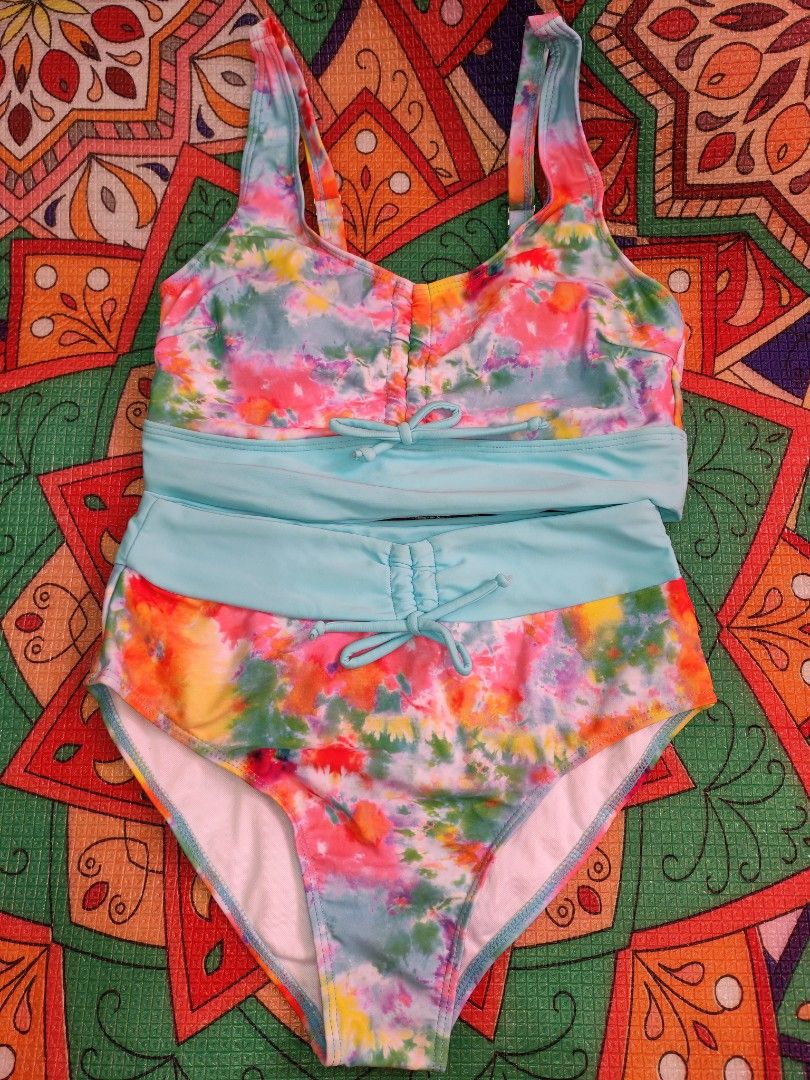 Tie-Dye Bikini Set with Light Blue Accents (Category: Bikinis & Swimsuits) located in Manila. Submitted by bavinsauga (Listing ID 1461869884, Image 3). Description: - Medium on tag - Almost like new - Reason for selling: Too small for me. Need to declutter. - Top features adjustable straps for a perfect fit. - High-waisted bottoms for a flattering silhouette. - Adjustable drawstring tie on the bottoms. - Stylish light blue waistband and trim. - I