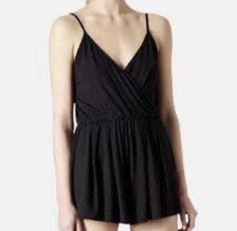 Topshop Black Wrap Front Playsuit Romper (Category: Rompers) located in Tanauan. Submitted by rie098 (Listing ID 1461911388, Image 1). Description: - Topshop black playsuit - Wrap front design - Delicate spaghetti straps - Comfortable elasticated waist - Flattering flared shorts - Versatile for casual days or evening events - Pairs well with sneakers or heels.