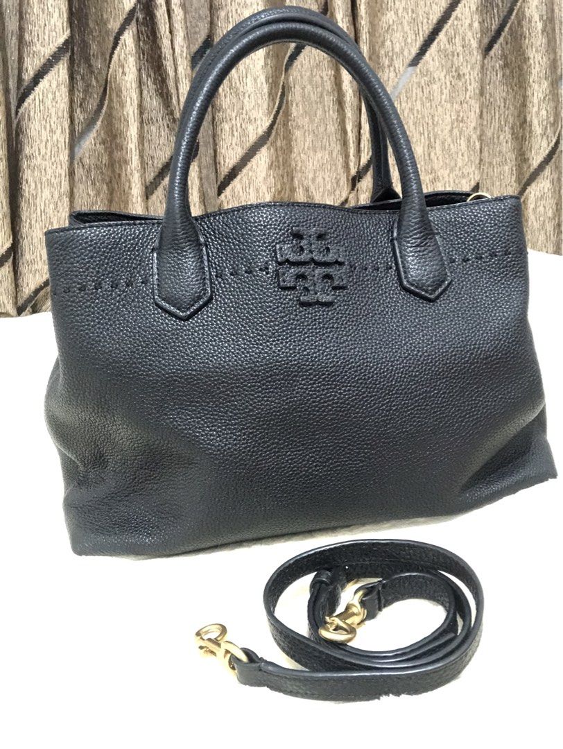 Tory Burch Black Leather Tote Bag with Shoulder Strap (Category: Luxury Bags & Wallets) located in Rizal. Submitted by elviedc2420209 (Listing ID 1461977547, Image 1). Description: - Brand: Tory Burch - Material: Black pebbled leather - Features: Top handles, detachable shoulder strap - Interior: Zippered pockets - Hardware: Gold details - Style: Spacious and versatile tote, ideal for everyday use.