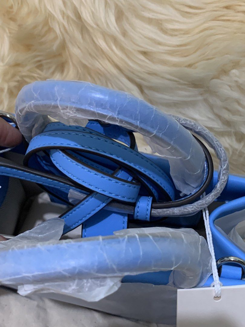 Tory Burch Perforated Logo Tote Bag - Light Blue (Category: Luxury Bags & Wallets) located in Manila. Submitted by mylildarlingamari (Listing ID 1461897411, Image 2). Description: - Light blue Tory Burch tote bag - Signature perforated logo on the front - Features top handles - Comes with a detachable shoulder strap - Brand new with original tags attached - Perfect size for everyday essentials.