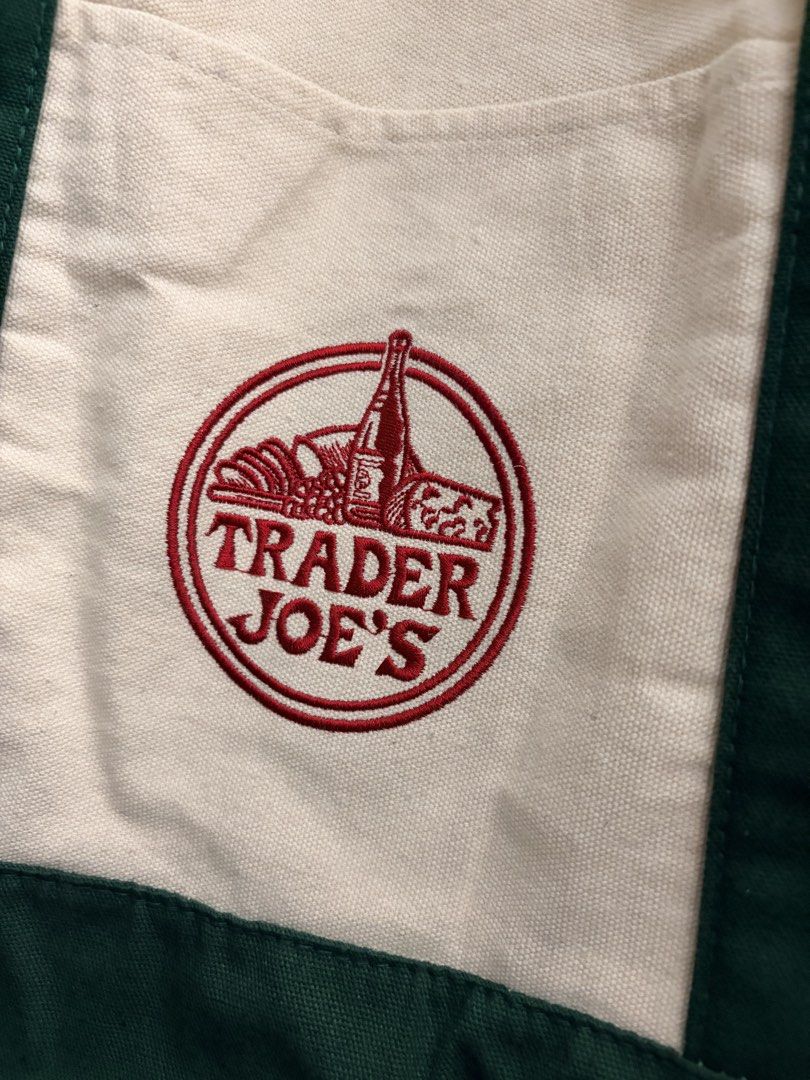 Trader Joe's Canvas Tote Bag (Category: Tote Bags) located in Manila. Submitted by finderskeepersmnl_092026 (Listing ID 1461957131, Image 2). Description: - Classic Trader Joe's canvas tote bag - Cream colored body - Dark green handles and base - Features iconic embroidered Trader Joe's logo - Ideal for grocery shopping or everyday errands - Durable and reusable design.