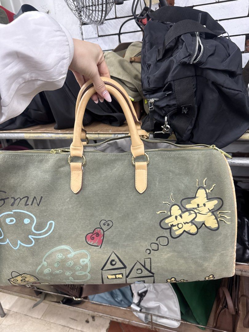 travel bag (Category: Beach Bags) located in Manila. Submitted by fastlion.584bdf (Listing ID 1461815140, Image 3). Description: - Unique travel duffel bag - Features a charming hand-painted design (sun, house, airplane, etc.) - Durable olive green canvas material - Stylish tan leather trim and handles - Spacious interior for your essentials - issue posted.