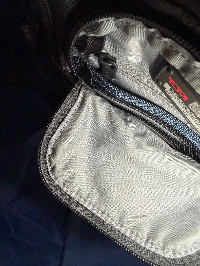 TUMI - Black Sling Bag (Category: Luxury Bags & Wallets) located in Las Pinas. Submitted by nproducts (Listing ID 1461937246, Image 2). Description: Type: Sling Bag Color: Black (Adjustable body strap) Bought from: TUMI Store - Greenbelt, Makati Classification: 100% Original item Condition: Good as new, used several times only Reason for selling: Not using it anymore (Decluttering) Selling Price: P 7,000.00 (Negotiable) - Interior view of a Tumi 