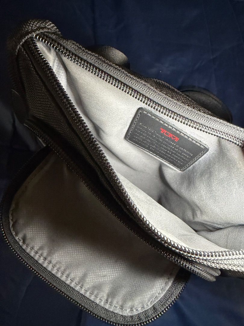 TUMI - Black Sling Bag (Category: Luxury Bags & Wallets) located in Las Pinas. Submitted by nproducts (Listing ID 1461937246, Image 3). Description: Type: Sling Bag Color: Black (Adjustable body strap) Bought from: TUMI Store - Greenbelt, Makati Classification: 100% Original item Condition: Good as new, used several times only Reason for selling: Not using it anymore (Decluttering) Selling Price: P 7,000.00 (Negotiable) - Interior view of a Tumi 