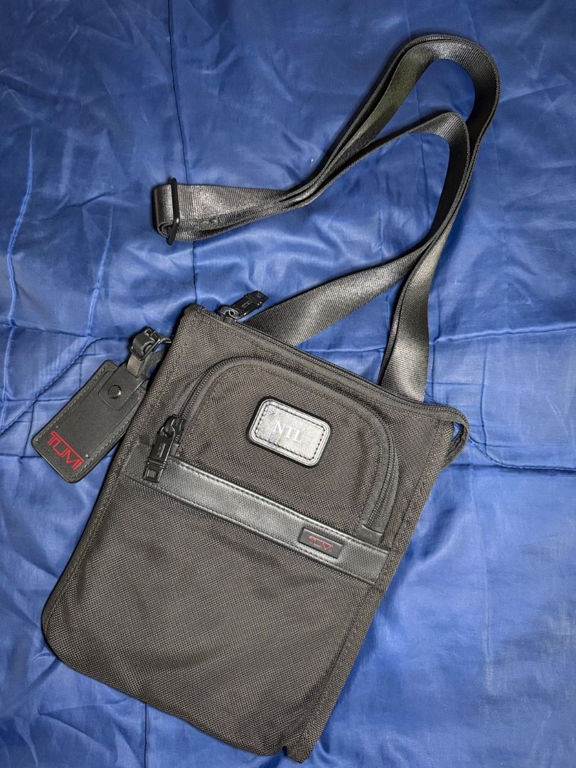 TUMI - Black Sling Bag (Category: Luxury Bags & Wallets) located in Las Pinas. Submitted by nproducts (Listing ID 1461937246, Image 1). Description: Type: Sling Bag Color: Black (Adjustable body strap) Bought from: TUMI Store - Greenbelt, Makati Classification: 100% Original item Condition: Good as new, used several times only Reason for selling: Not using it anymore (Decluttering) Selling Price: P 7,000.00 (Negotiable) - Interior view of a Tumi 
