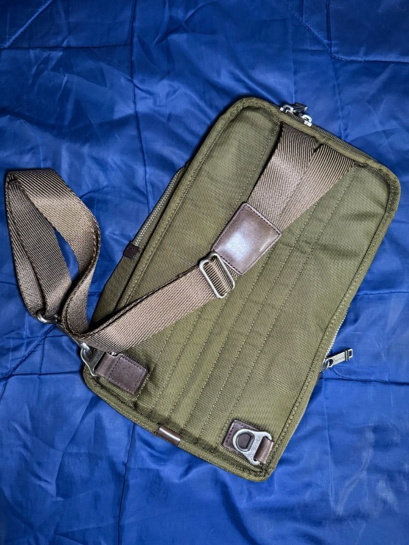 Tumi Green Nylon - Sling Bag (Category: Sling Bags) located in Las Pinas. Submitted by nproducts (Listing ID 1461937511, Image 3). Description: Type: Sling Bag Color: Army Green (Adjustable body strap) Bought from: TUMI Store - Manila Classification: 100% Original item Condition: Good as new, used several times Reason for selling: Not using it anymore (Decluttering) Selling Price: P 8,000.00 (Negotiable) - Olive green Tumi sling bag - Durable nyl