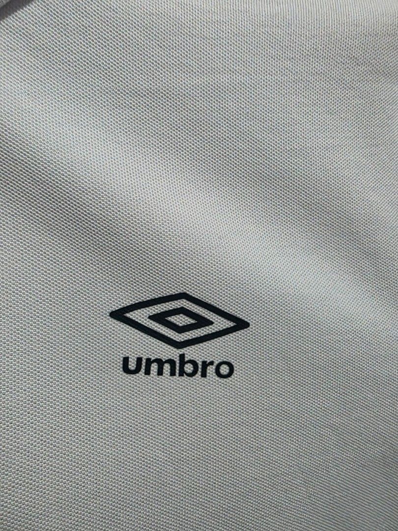 Umbro White Polo Shirt (Category: Tshirts & Polo Shirts ) located in Quezon City. Submitted by kick_mnl (Listing ID 1461867757, Image 1). Description: - Classic white Umbro polo shirt - Features a traditional collar with button closure - Short sleeves with comfortable ribbed cuffs - Versatile design suitable for casual outings or sports activities.